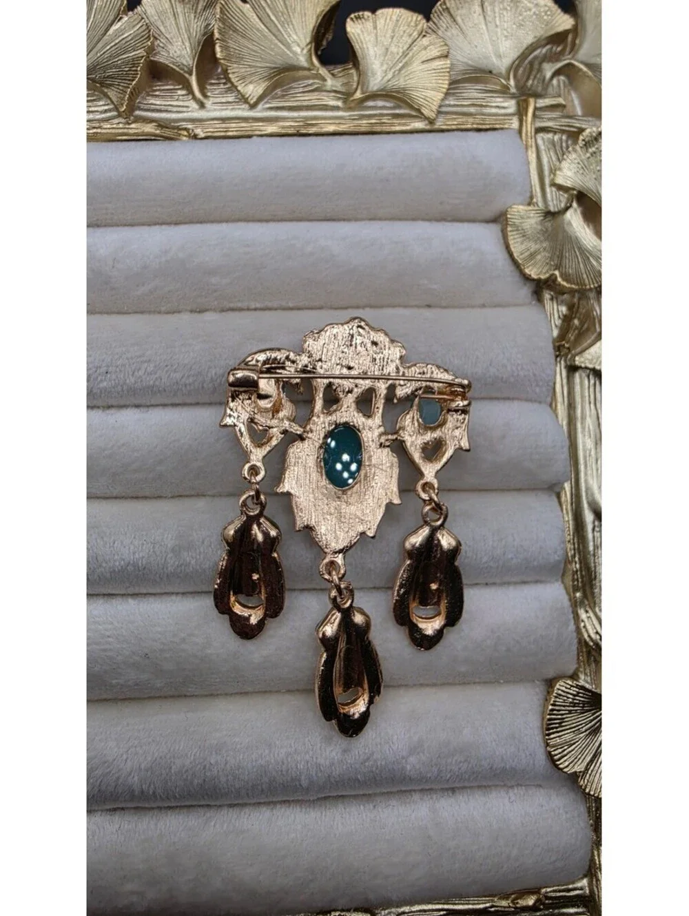 Vintage-Inspired Teal Gemstone Brooch with Dangling Design